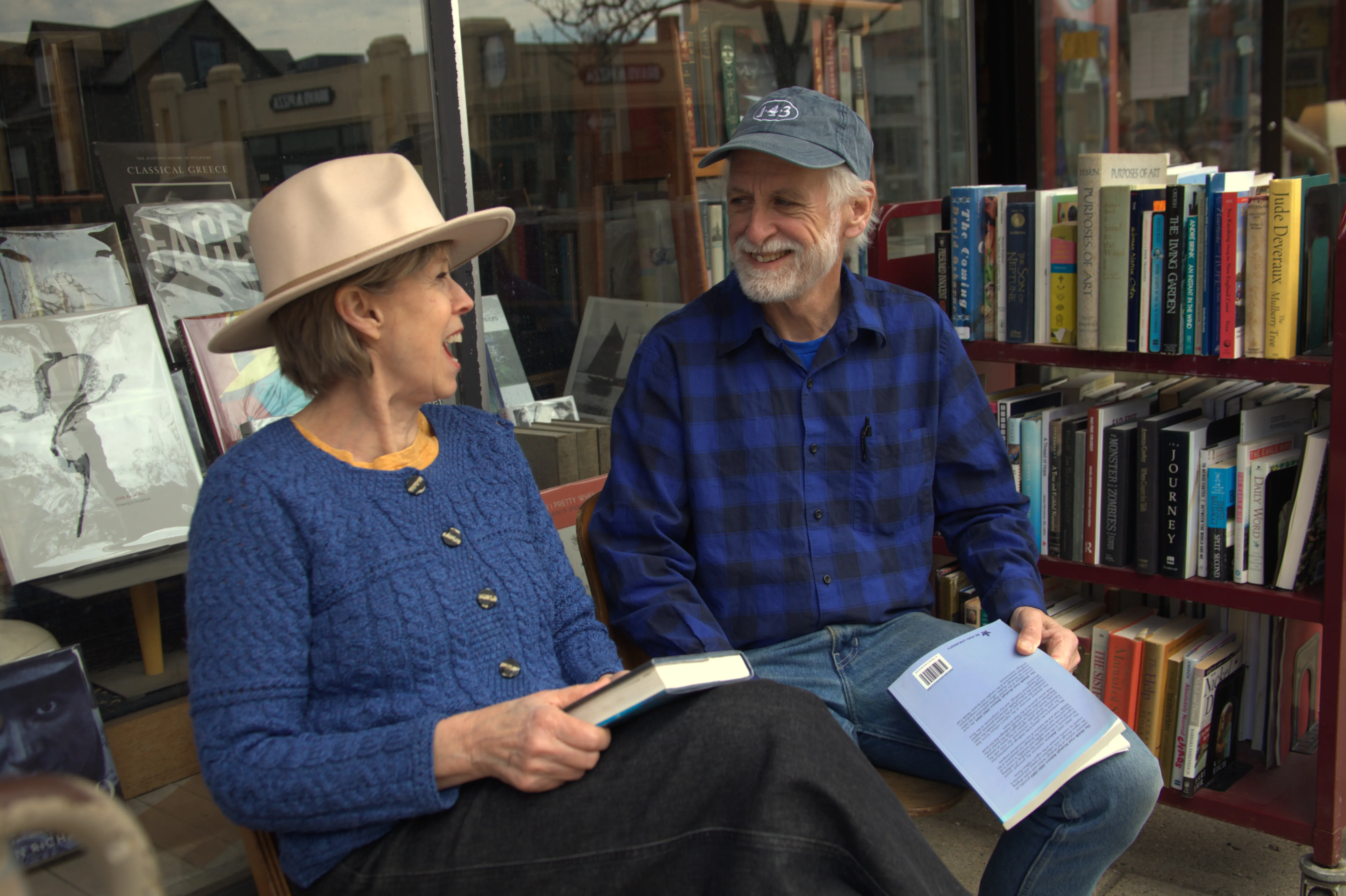 Couple seated on a bench outside the library enjoying an intimate, colorful moment together